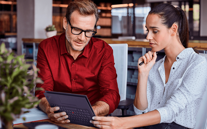 Man and woman using Lenovo laptop folded