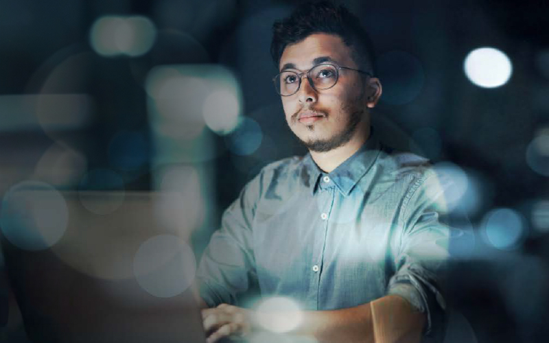 Man looking at data on a computer