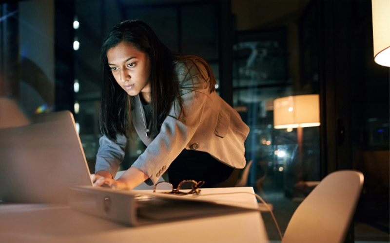 Woman sat at a desk using a computer
