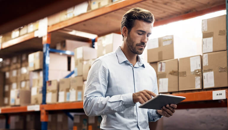 Man doing inventory management in warehouse