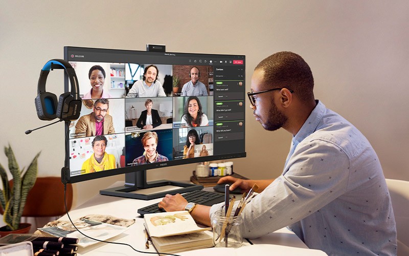 Man in checked shirt using a Philips display