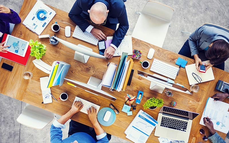 A Multinational Financial Services provider Business meeting with Apple devices