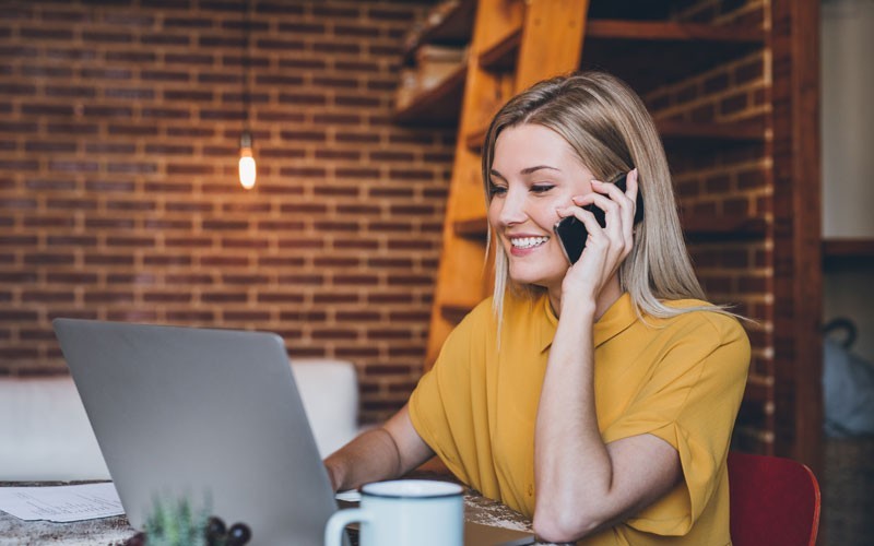 IT refresh Woman on phone and laptop
