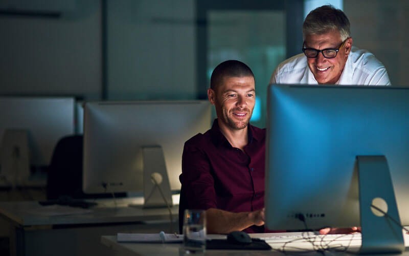 Dell next-generation firewalls and unified threat management firewalls Two men working together at desk