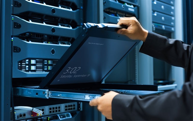 Dell EMC security services Dell employee in server room about to use laptop