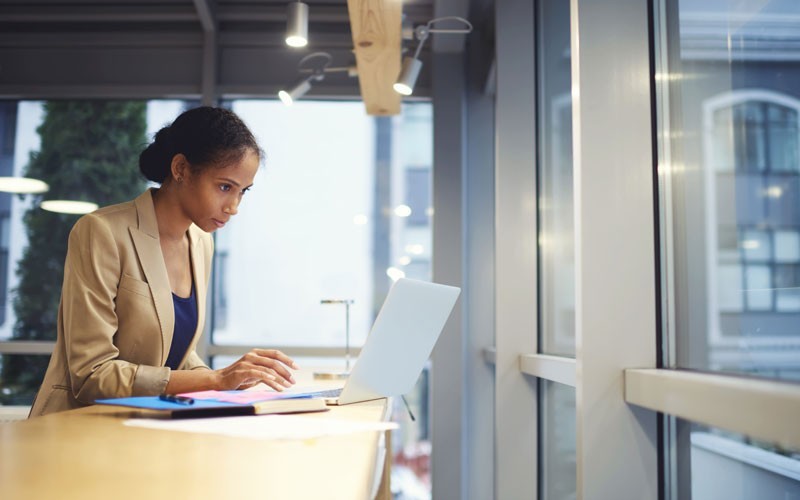 Custom virtual desktop technology Woman working remotely on laptop device