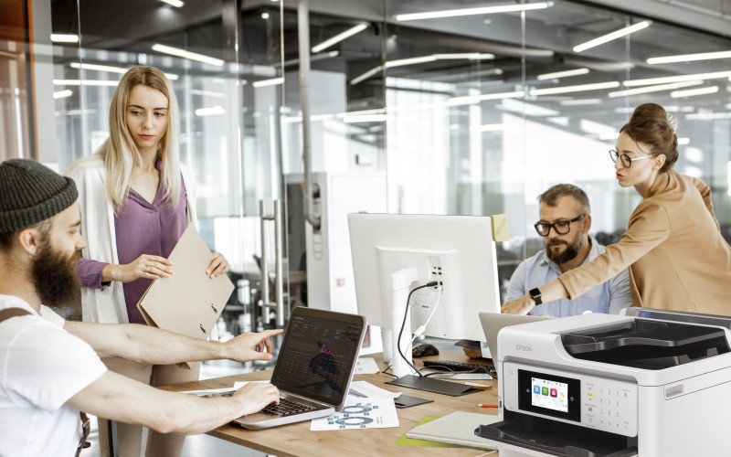 Male creative designer printing marketing material at Epson printer