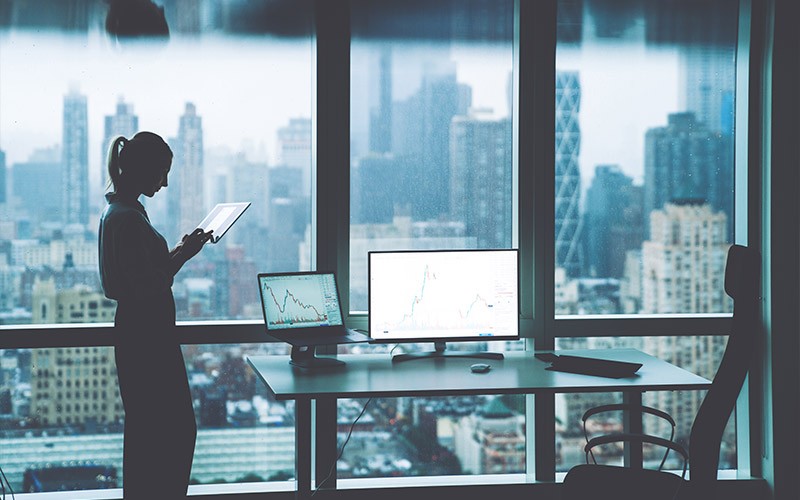 Woman using tablet next to a desk
