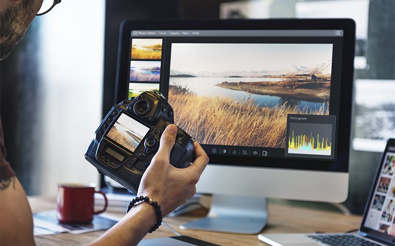 Man reviewing photos from DSLR camera