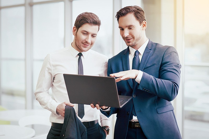 Lenovo is the ideal technology partner for every infustry Two males looking at black laptop