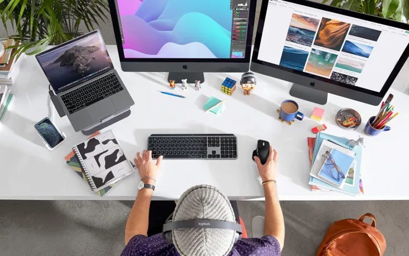 Designer working on PC with Logitech mouse