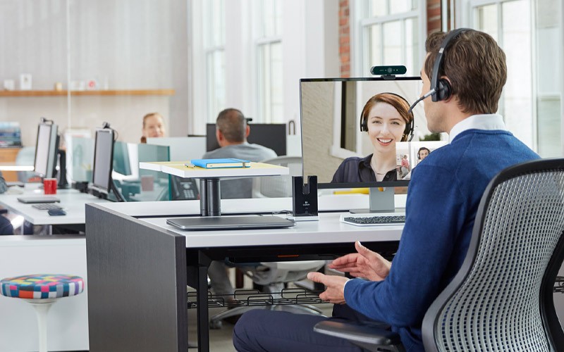 Enhance business productivity and improve creativity Man using Logitech solutions for a conference call