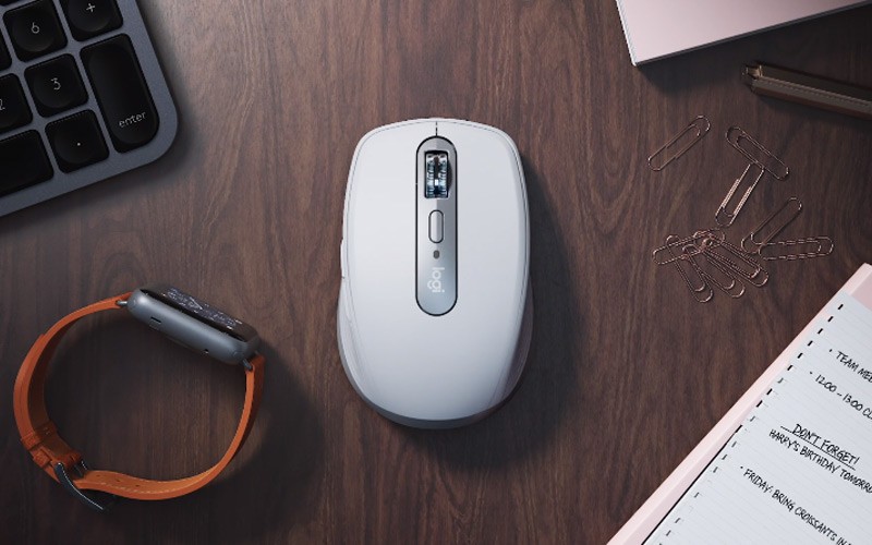 Ultimate versatility with remarkable performance Logitech MX mouse on a desk next to a watch