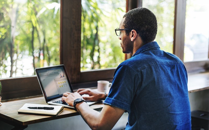 Male using laptop device