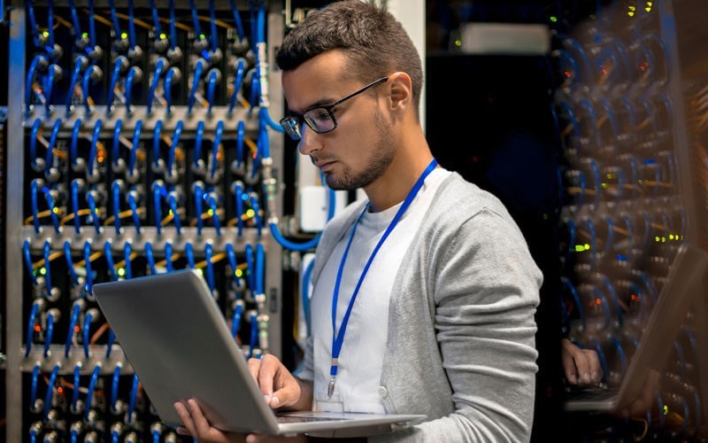 Easily move data across flash, disk and cloud resources. Young man working in a data centre