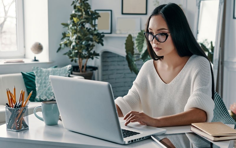 Woman on laptop computer with tablet nearby on desk Deliver fast, consistent protection