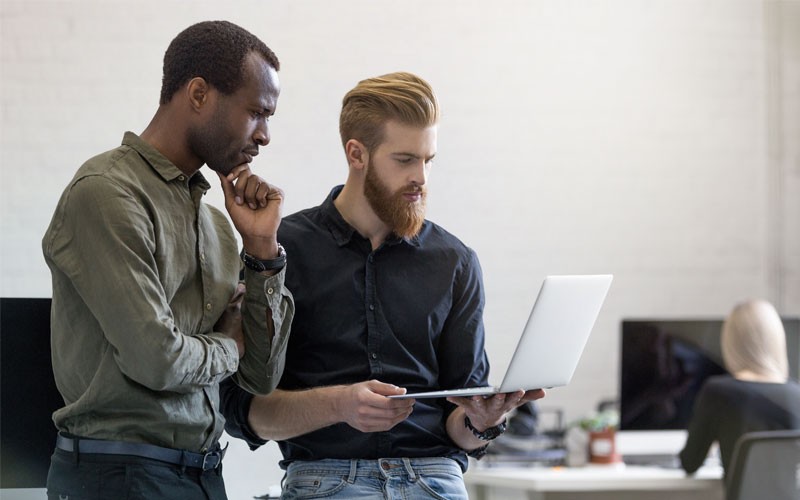 male-employees-collaborating-laptop